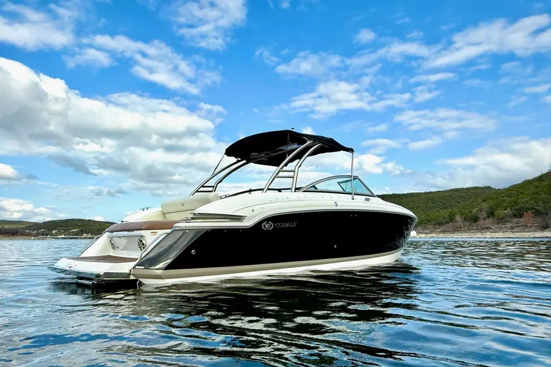 Slide: The Image of 2011 Cobalt 276 boat on a serene lake under a blue sky. - 7