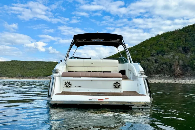 Slide: The Image of 2011 Cobalt 276 boat on a lake with scenic hills and cloudy sky. - 8