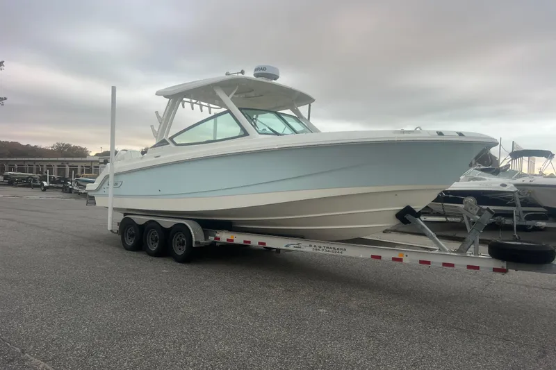 The Image of 2023 Boston Whaler 280 Vantage boat on trailer, parked in marina lot. - 0
