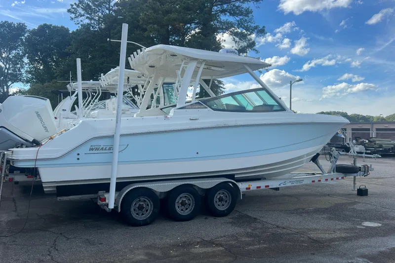 Slide: The Image of 2023 Boston Whaler 280 Vantage boat on trailer, parked outdoors under blue sky. - 18