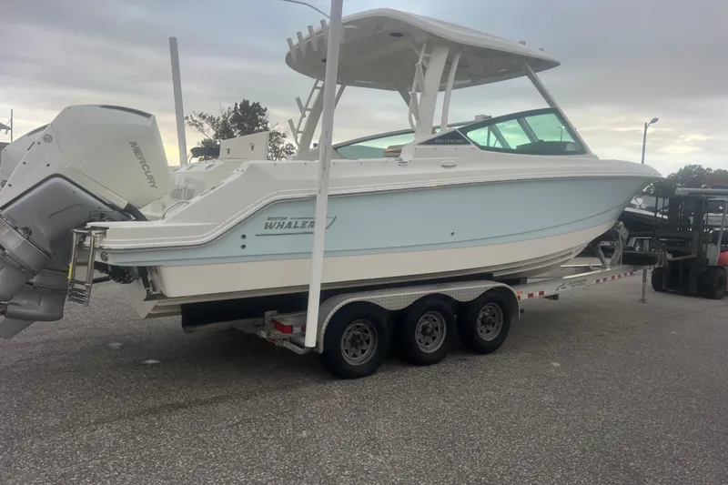 Slide: The Image of 2023 Boston Whaler 280 Vantage boat on a trailer, featuring dual Mercury engines. - 23