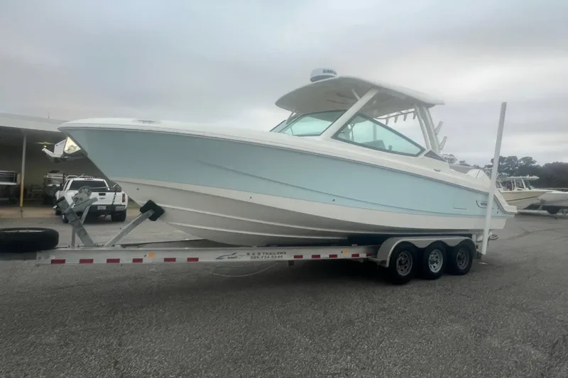 Slide: The Image of 2023 Boston Whaler 280 Vantage boat on a trailer in a parking lot. - 26