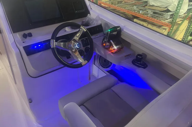 Slide: The Image of 2023 Boston Whaler 280 Vantage helm with illuminated controls and modern steering wheel. - 32
