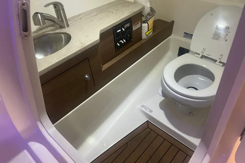 Slide: The Image of 2023 Boston Whaler 280 Vantage boat bathroom with sink and toilet. - 34