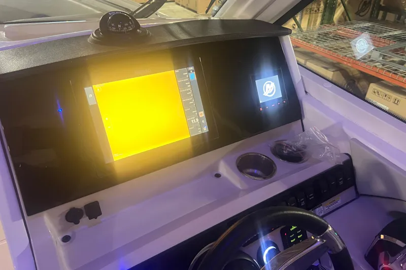 Slide: The Image of 2023 Boston Whaler 280 Vantage dashboard with navigation screens and controls. - 35