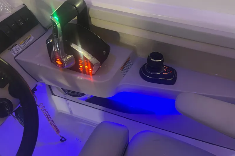 Slide: The Image of 2023 Boston Whaler 280 Vantage boat controls with illuminated dashboard and throttle. - 36