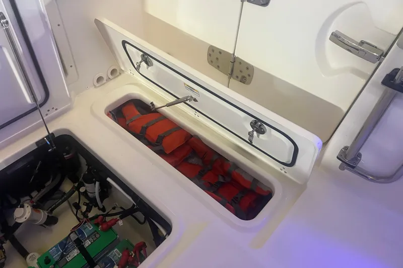 Slide: The Image of 2023 Boston Whaler 280 Vantage storage compartment with life jackets and equipment. - 40