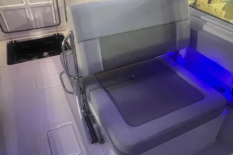 Slide: The Image of 2023 Boston Whaler 280 Vantage interior seating with blue ambient lighting. - 42