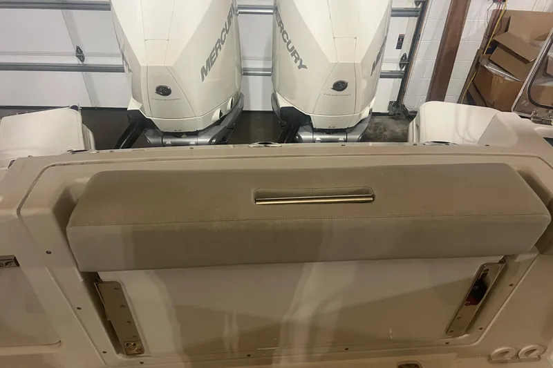 Slide: The Image of 2023 Boston Whaler 280 Vantage with dual Mercury outboard engines in a garage setting. - 46