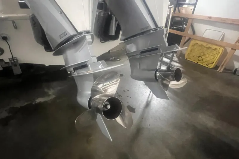 Slide: The Image of Twin propellers of a 2023 Boston Whaler 280 Vantage boat in a garage. - 56