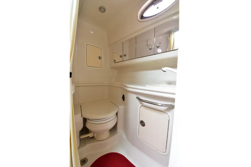 Slide: The Image of Compact bathroom in 2006 Sea Ray 320 Sundancer yacht with toilet and storage cabinets. - 17