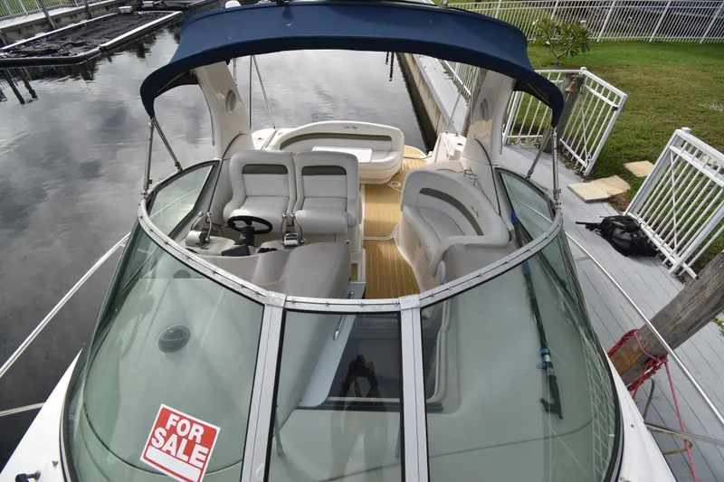 Slide: The Image of 2006 Sea Ray 320 Sundancer boat with "For Sale" sign, docked at marina. - 4