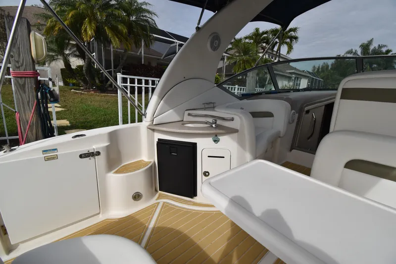 Slide: The Image of 2006 Sea Ray 320 Sundancer boat interior with seating and kitchenette area. - 7