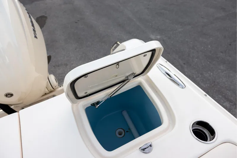 Slide: The Image of 2024 Grady-White Freedom 307 boat with open storage compartment and visible engine. - 11