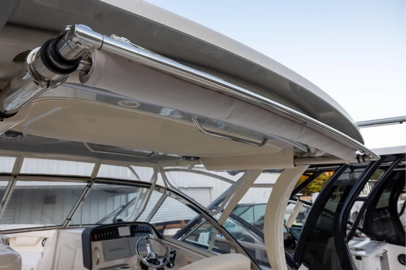 Slide: The Image of 2024 Grady-White Freedom 307 boat interior with steering wheel and canopy details. - 12