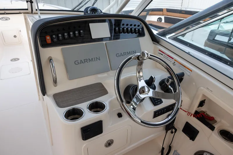 Slide: The Image of 2024 Grady-White Freedom 307 helm with Garmin displays and modern controls. - 13