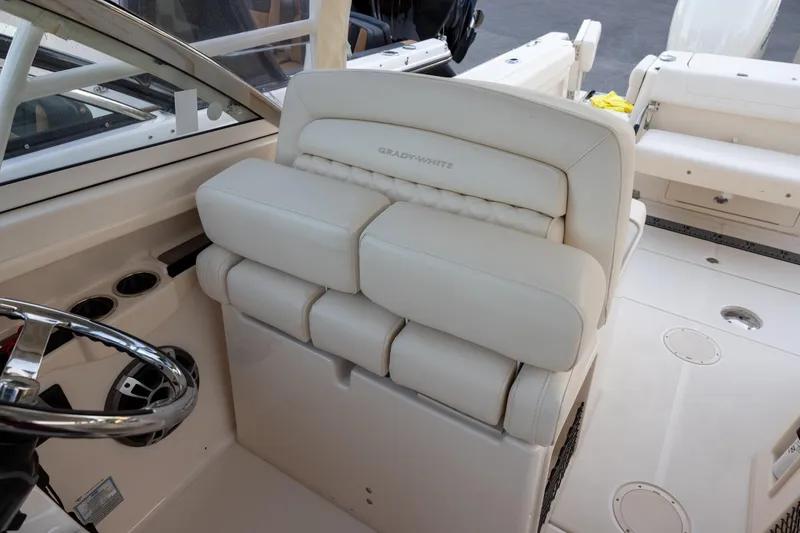 Slide: The Image of 2024 Grady-White Freedom 307 boat interior with plush seating and steering wheel. - 15