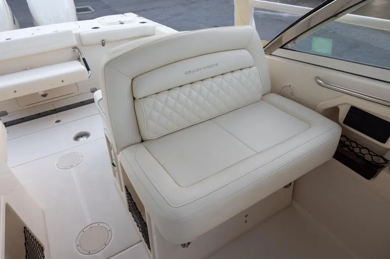 Slide: The Image of 2024 Grady-White Freedom 307 boat interior with luxurious white seating. - 16
