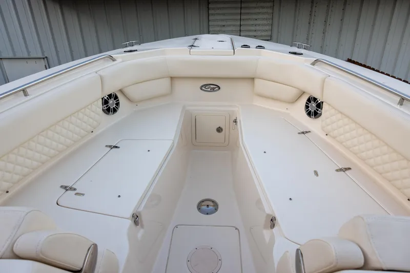 Slide: The Image of 2024 Grady-White Freedom 307 boat interior with white seating and storage compartments. - 19
