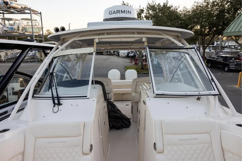 Slide: The Image of 2024 Grady-White Freedom 307 boat with Garmin equipment, docked in a marina setting. - 22