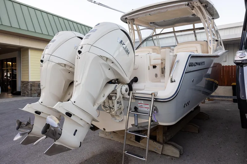 Slide: The Image of 2024 Grady-White Freedom 307 boat with dual Yamaha outboard engines displayed outdoors. - 4