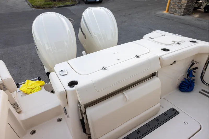 Slide: The Image of 2024 Grady-White Freedom 307 boat deck with dual engines and seating area. - 6