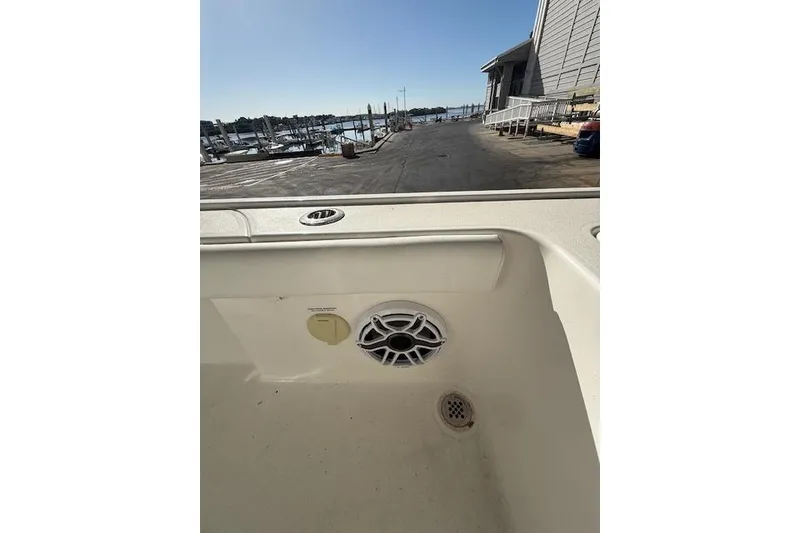 Slide: The Image of 2025 Caymas 28 HB boat docked at a marina with clear blue skies. - 10