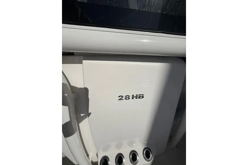 Slide: The Image of Helm of 2025 Caymas 28 HB boat with dual screens and steering wheel. - 11