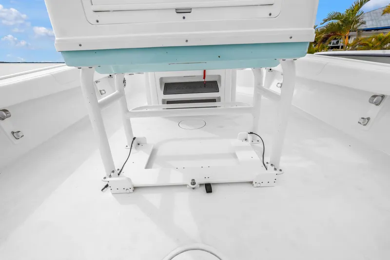 Slide: The Image of 2025 Caymas 28 HB boat interior, showcasing spacious white deck and seating area. - 14