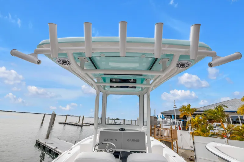 Slide: The Image of 2025 Caymas 28 HB boat with T-top and Garmin electronics, docked by a marina. - 15