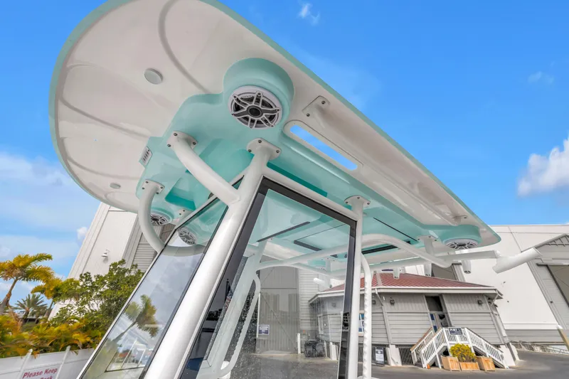 Slide: The Image of 2025 Caymas 28 HB boat with sleek design and modern features, docked outdoors. - 16