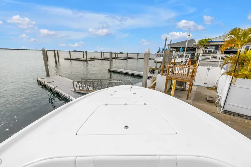 Slide: The Image of 2025 Caymas 28 HB boat docked at a marina with clear blue skies. - 18