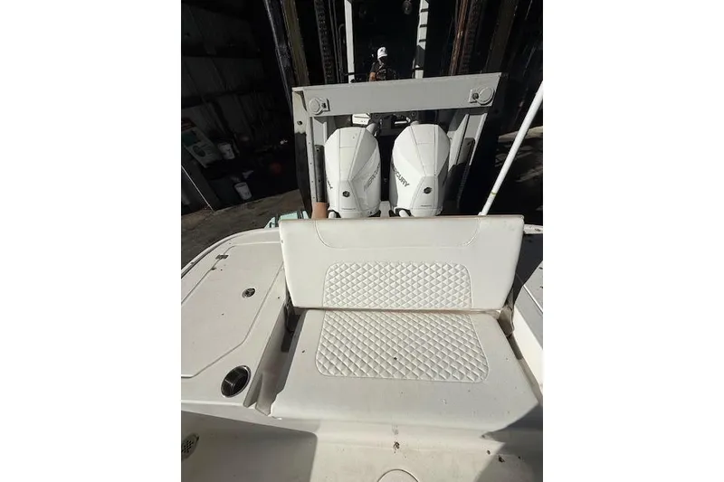 Slide: The Image of 2025 Caymas 28 HB boat docked, featuring sleek design and powerful Mercury engine. - 2