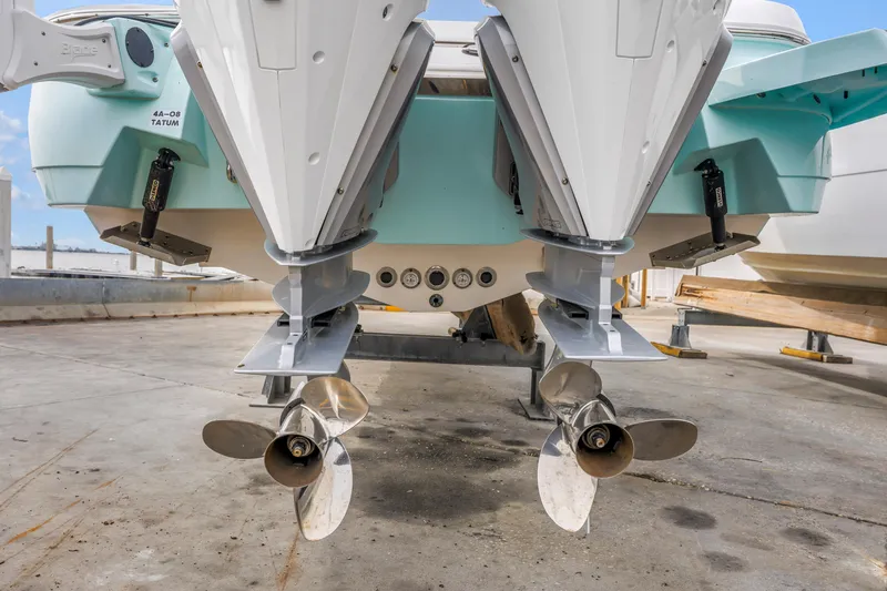 Slide: The Image of Rear view of 2025 Caymas 28 HB boat with dual outboard motors. - 24