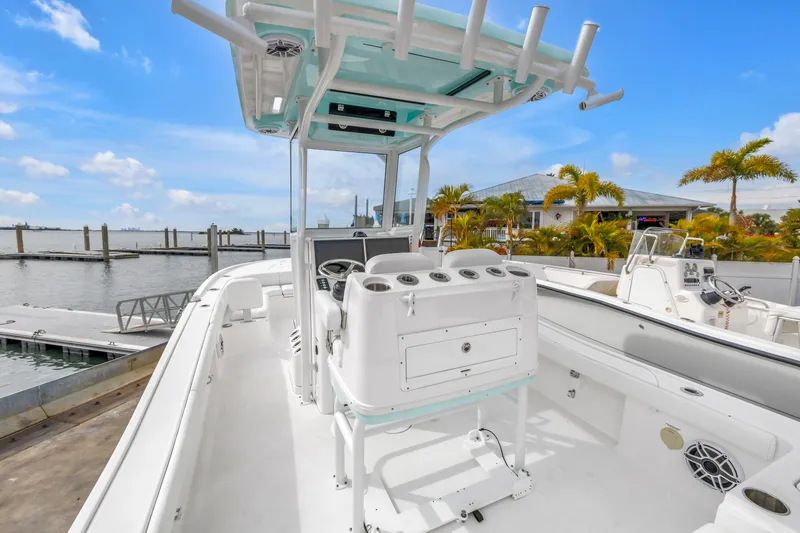 Slide: The Image of 2025 Caymas 28 HB boat interior with helm station, docked by waterfront. - 25