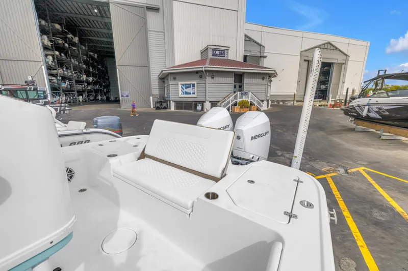 Slide: The Image of 2025 Caymas 28 HB boat with Mercury engines at a marina storage facility. - 26