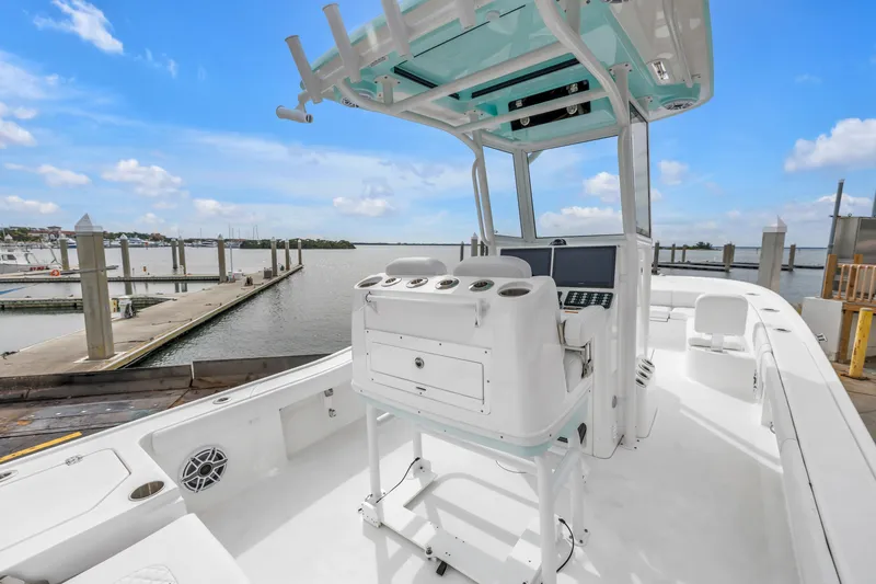 Slide: The Image of 2025 Caymas 28 HB boat at marina, featuring modern helm and spacious deck. - 28