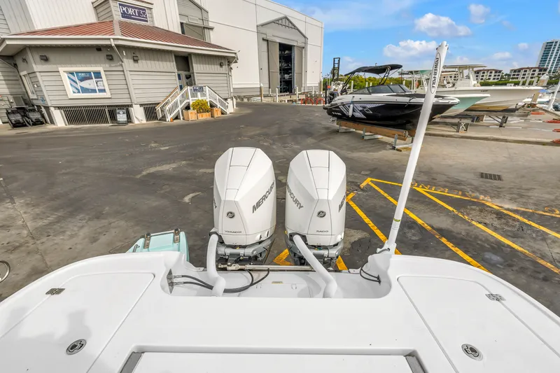 Slide: The Image of 2025 Caymas 28 HB boat with dual Mercury engines at a marina dock. - 29