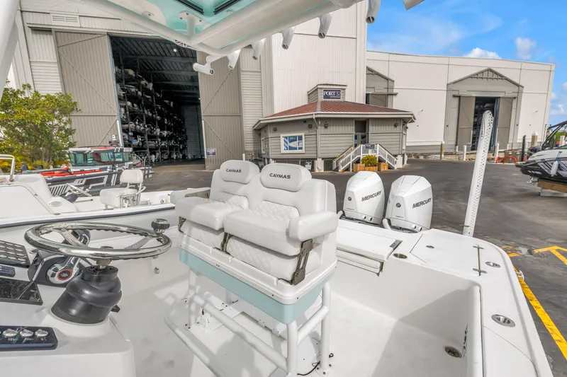 Slide: The Image of 2025 Caymas 28 HB boat with dual Mercury engines at a marina. - 33