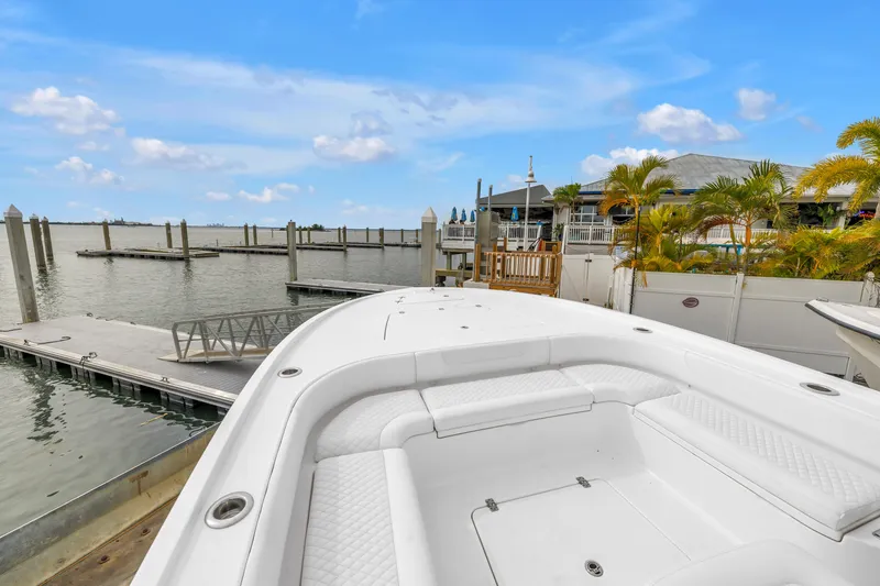 Slide: The Image of 2025 Caymas 28 HB boat docked at marina with clear blue sky. - 34