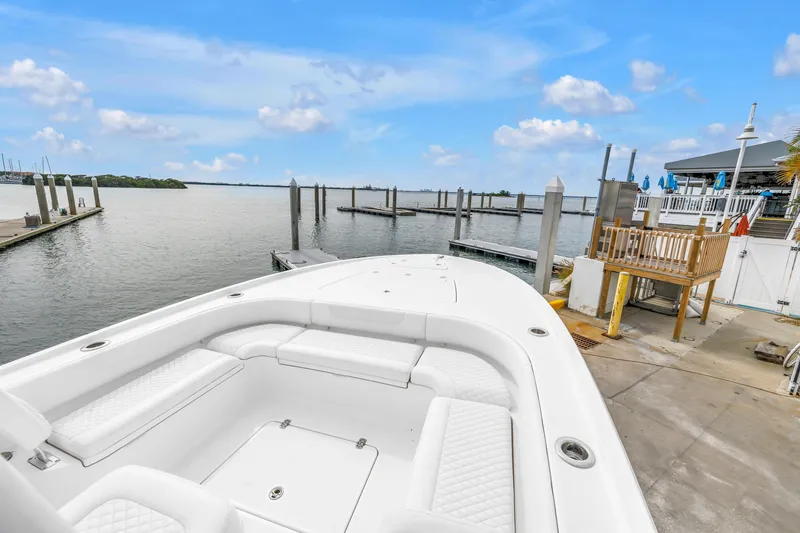 Slide: The Image of 2025 Caymas 28 HB boat docked at marina with clear blue sky. - 35