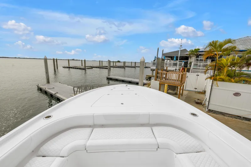 Slide: The Image of 2025 Caymas 28 HB boat docked at a marina with clear blue skies. - 36