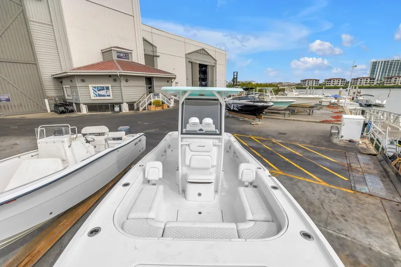 Slide: The Image of 2025 Caymas 28 HB boat docked at a marina with clear blue skies. - 37