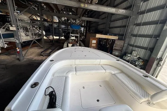 Slide: The Image of 2025 Caymas 28 HB boat on dock, light blue hull, marina background. - 4