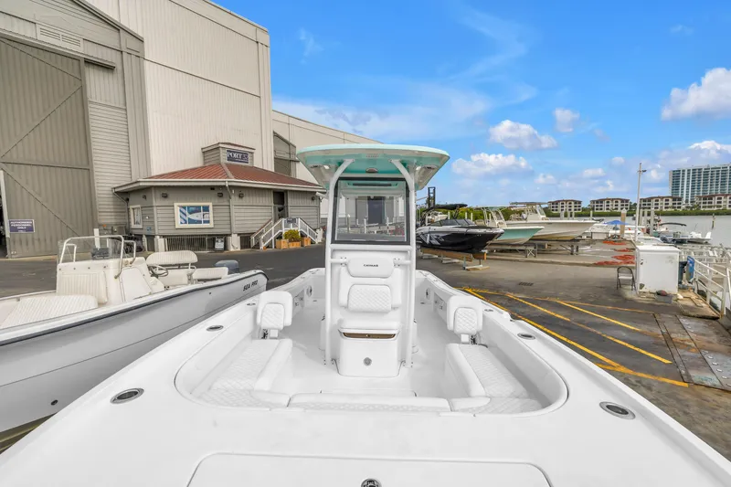 Slide: The Image of 2025 Caymas 28 HB boat docked at a marina with clear blue skies. - 40