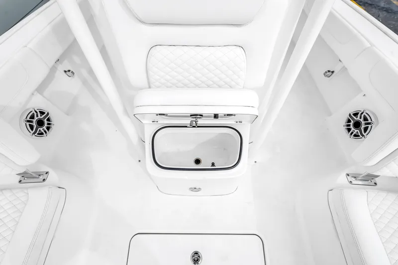 Slide: The Image of 2025 Caymas 28 HB boat interior with white seating and built-in speakers. - 41