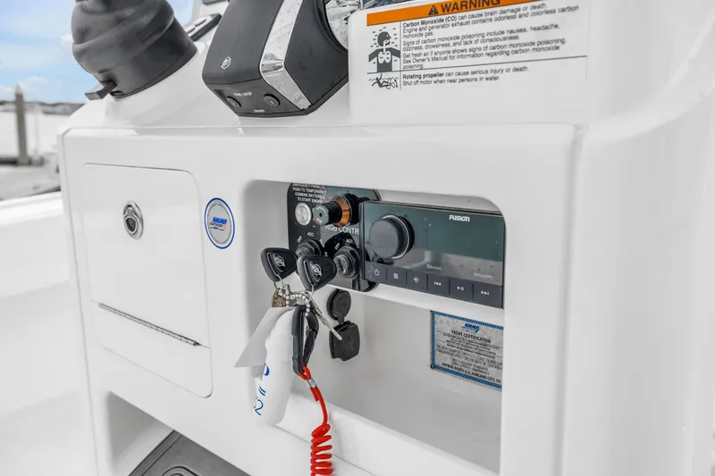 Slide: The Image of Control panel of 2025 Caymas 28 HB boat with audio system and safety warnings. - 42