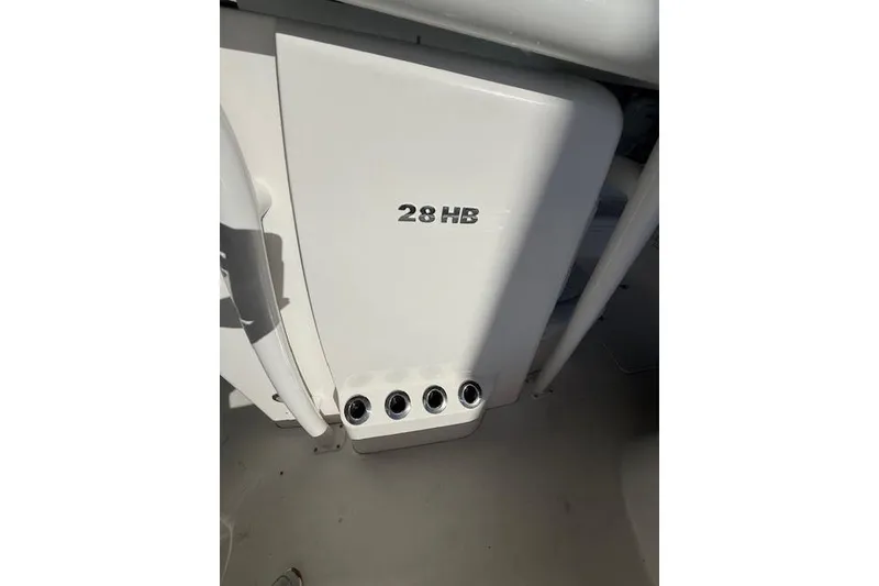 Slide: The Image of 2025 Caymas 28 HB with dual Mercury Verado outboard engines in a marina setting. - 9