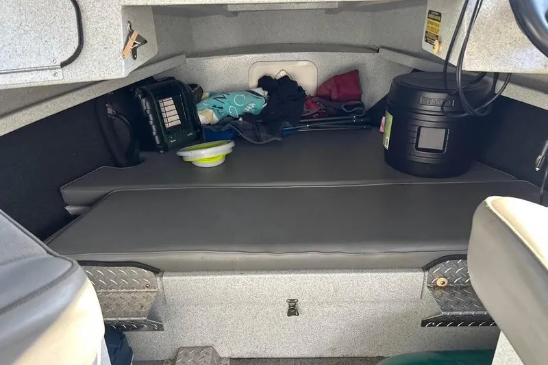 Slide: The Image of Interior of a 2004 Boulton Explorer 24 boat with storage and seating area. - 8