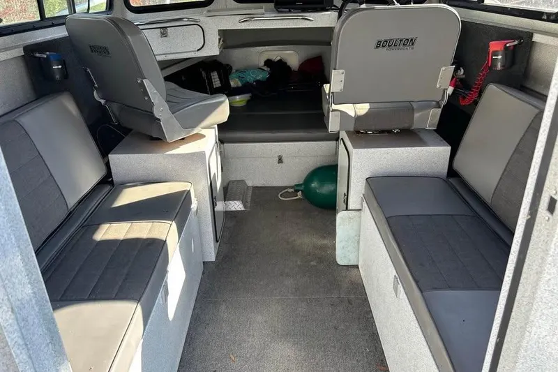 Slide: The Image of Interior of a 2004 Boulton Explorer 24 boat with seating and storage. - 9